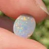 Semi-black solid opal 0.6 ct from Lightening Ridge.